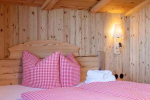 a bedroom with two beds with pink and white pillows at Golmerhaus in Schruns