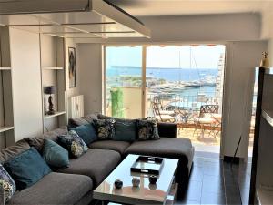 a living room with a couch and a table at O Festival Palace, terrace with panoramic sea view in Cannes