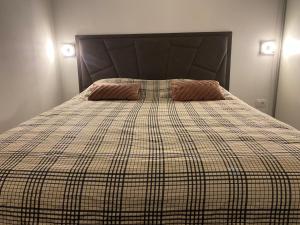 a bed with two pillows on top of it at Royal 2 **** in Slavonski Brod