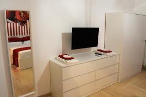 A television and/or entertainment centre at Melograno Home