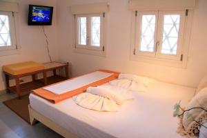 A bed or beds in a room at Margado