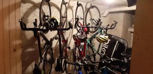 a bunch of bikes hanging on a wall at Chambres d'hôtes Nilautpala Dreams in Saint-Jean-de-Maurienne