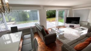 a living room with a couch and a tv at Broad Mead in Corfe Castle