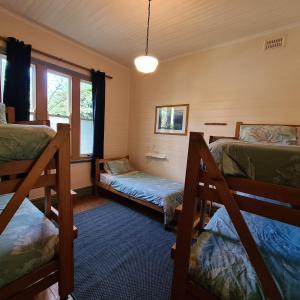 a room with two bunk beds and a window at No14 Lovel St in Katoomba