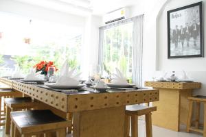 a dining room with a table with plates and wine glasses at Jasmine Chiangmai Boutique Hotel in Chiang Mai +15 photos