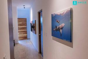 a hallway with a painting of a dolphin on the wall at Ancla Baja Living Condominio nuevo con vista 4 in La Paz