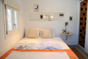 A bed or beds in a room at Margado
