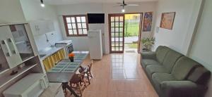 a living room with a couch and a table at Recanto da Madre in Guarda do Embaú