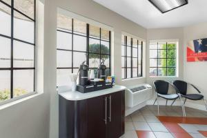 a home office with a desk and two chairs and windows at Motel 6-Merced, CA - North in Merced