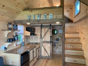 a kitchen with a barn door in a tiny house at Riverbottom - Tiny Home 2 in Bellevue