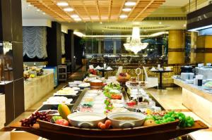 a buffet line with many different types of food at Topland Hotel & Convention Centre in Phitsanulok
