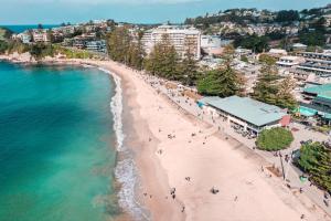 an aerial view of a beach and the ocean at Terrigal Pacific Coastal Retreat in Terrigal