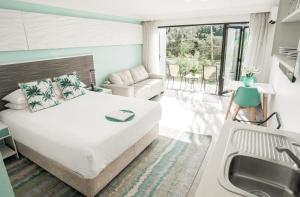 a bedroom with a bed and a sink and a couch at Terrigal Pacific Coastal Retreat in Terrigal +76 photos