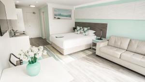 a living room with a bed and a couch at Terrigal Pacific Coastal Retreat in Terrigal +66 photos