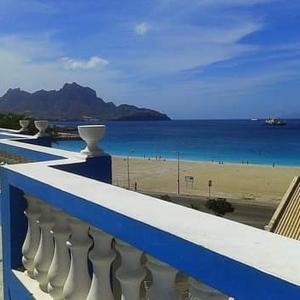 a blue and white balcony with a view of a beach at Residencial Laginha in Mindelo