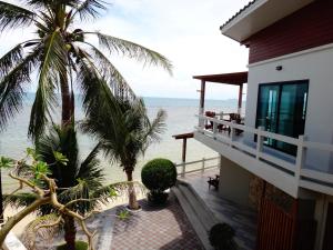 a view of the beach from the balcony of a house at Neptune's Villa in Haad Rin