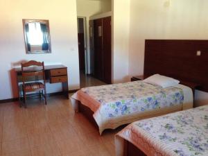 Postel nebo postele na pokoji v ubytování Residencial Laginha
