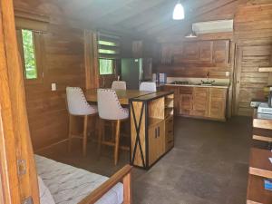 a kitchen with wooden cabinets and a counter top at Cabañas Corazón in Troncones