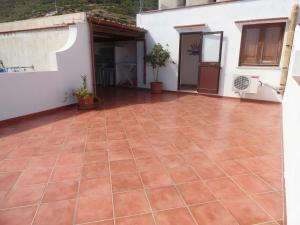 a courtyard with a tile floor in front of a house at Il Cortile Di Eolo in Marettimo