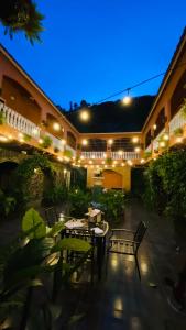 an outdoor patio with tables and chairs at night at La Serrania B&B in Boquete