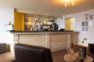 een bar in een kamer met een tafel en stoelen bij Imperial Hotel Tenby in Tenby