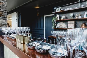 a bar with glasses and bowls on a counter at HUs - Boutique Venue & Accommodation in Riverhead
