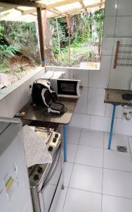 a small kitchen with a sink and a stove at Bosque dos Esquilos in Abraão