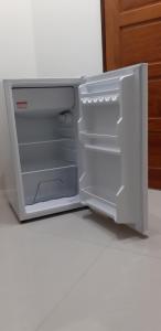 a refrigerator with its door open in a kitchen at 宜蘭樸實園民宿 in Jiaoxi