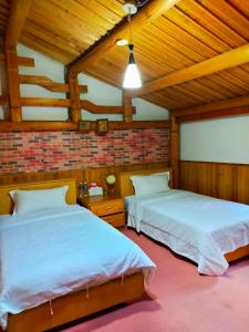 Postel nebo postele na pokoji v ubytování Jinsha Old Street B&B