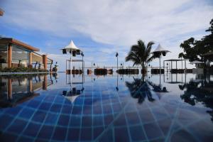 a large swimming pool with trees at AKIRA Lipe Resort in Ko Lipe