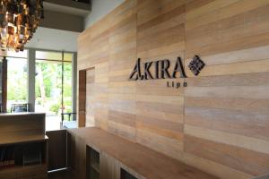 a wooden wall with a akira logo on it at AKIRA Lipe Resort in Ko Lipe
