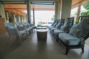 a row of chairs and a table in a building at AKIRA Lipe Resort in Ko Lipe