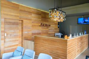 a restaurant with a bar with blue chairs and a chandelier at AKIRA Lipe Resort in Ko Lipe