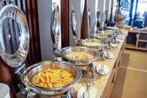 a buffet line of bowls of food on a table at AKIRA Lipe Resort in Ko Lipe