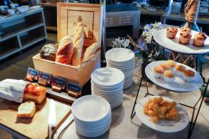 a table with plates of bread and pastries on it at AKIRA Lipe Resort in Ko Lipe