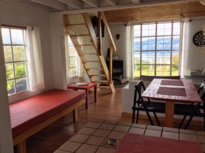 a living room with a staircase and a table and chairs at Chalet XIVA in Guatavita