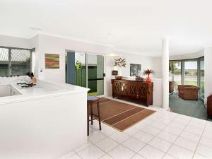 
a living room filled with furniture and a large window at Busselton Beach House in Busselton

