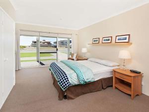 
a bedroom with a bed and a desk at Busselton Beach House in Busselton
