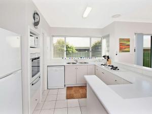 
a kitchen with a sink and a stove at Busselton Beach House in Busselton
