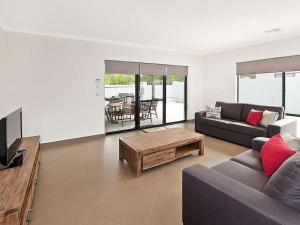 a living room with a couch and a coffee table at Ocean Walk Abbey in Vasse