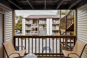 a porch with chairs and a balcony with a apartment at Sandalwood 203B in Ocean City