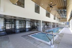 a large swimming pool in a building with a pool at Outrigger 114 in Ocean City