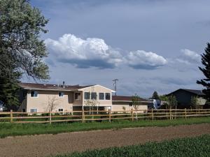 a house with a fence in front of it at Epic Sunsets in Bozeman - Wonderful View in Bozeman