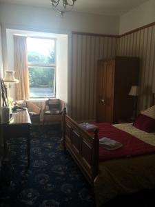 a hotel room with a bed and a window at Broom Lodge in Largs