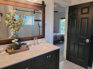 a bathroom with a sink and a large mirror at Among the Aspens Family Cottage in Bozeman +43 photos