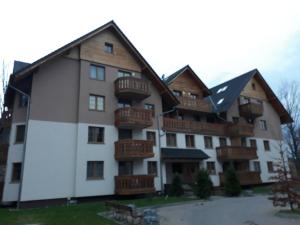 a building with balconies on the side of it at Holiday Hill Apartamenty Pogodny in Karpacz