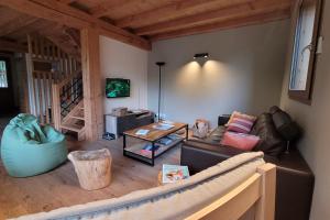 a living room with a couch and a table at Chalet l'ecrin - 6 pers with panoramic view of the Meije in La Grave