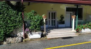 a house with stairs and potted plants in front of it at Modern Apt REVENTINO - Le Lincelle, Lamezia in SantʼEufemia Lamezia