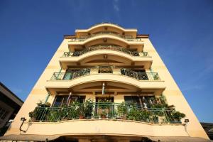 a tall building with balconies and plants on it at Baanthanam Nont in Nonthaburi