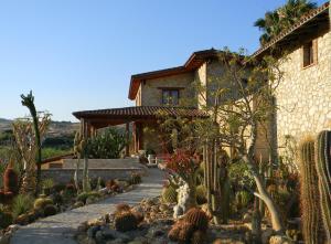a house with a bunch of cactus in front of it at Relais Garden Cactus B&B in Favara